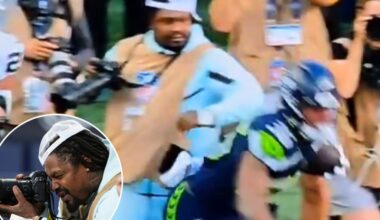 Marshawn Lynch stiff arms player to protect his camera during Seahawks preseason game