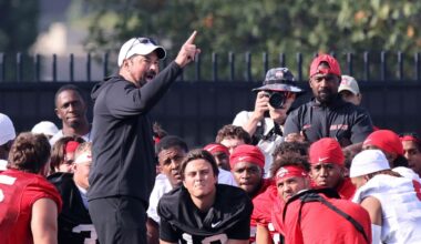Ohio State coach Ryan Day talks to his team during NCAA college football practice in Columbus, Ohio, Friday, Aug. 1, 2025. (AP Photo/Paul Vernon)