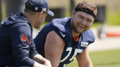 May 10, 2025; Lake Forest, IL, USA; Chicago Bears head coach Ben Johnson talks with offensive lineman (75) Ozzy Trapilo during rookie minicamp at Halas Hall.