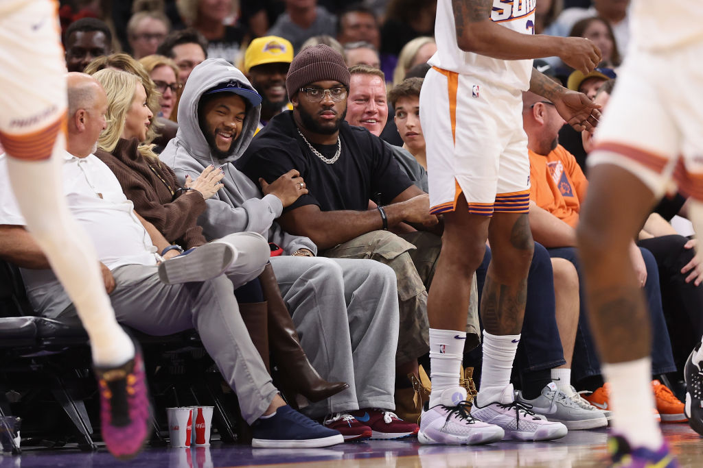 Paris Johnson Jr. and Kyler Murray look on during a Suns game...
