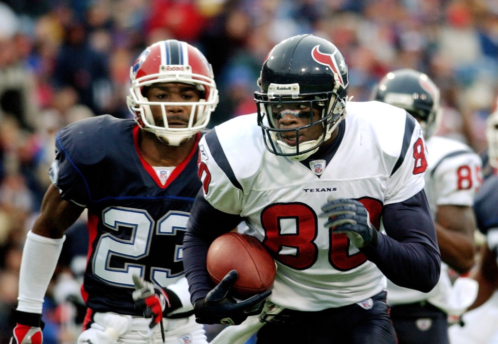 Andre Johnson (#80) of the Houston Texans running with the football, pursued by a Buffalo Bills player.