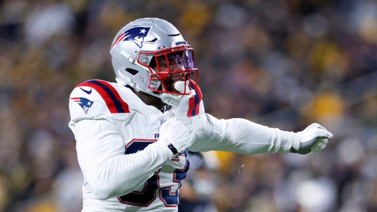 New England Patriots linebacker Anfernee Jennings (33) celebrates a tackle in the first half at Acrisure Stadium.