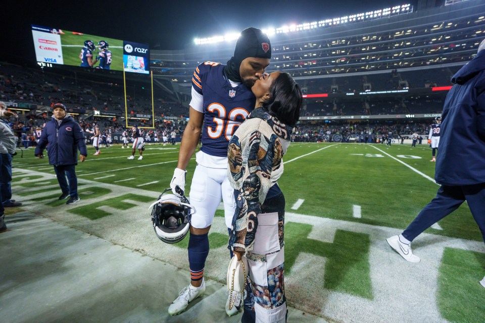 Simone Biles kissing her husband, Jonathan Owens, at a football game.