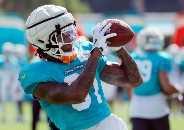 Miami Dolphins running back Ollie Gordon II catches a pass...