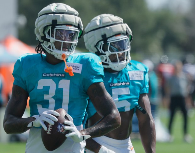 Miami Dolphins running backs Ollie Gordon II, left, and Jaylen...
