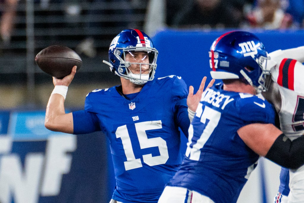 New York Giants quarterback Tommy DeVito throwing a football.