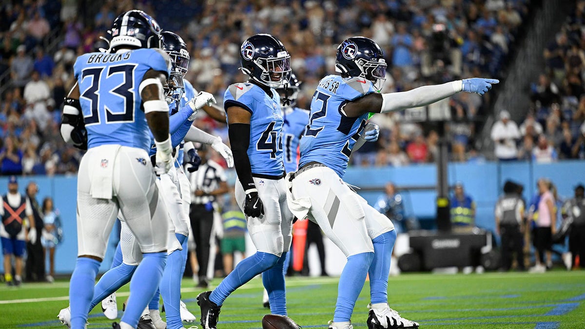 Titans players celebrate interception
