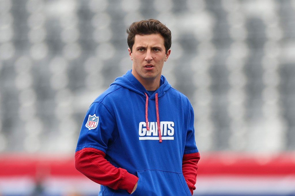 New York Giants player in blue hoodie.