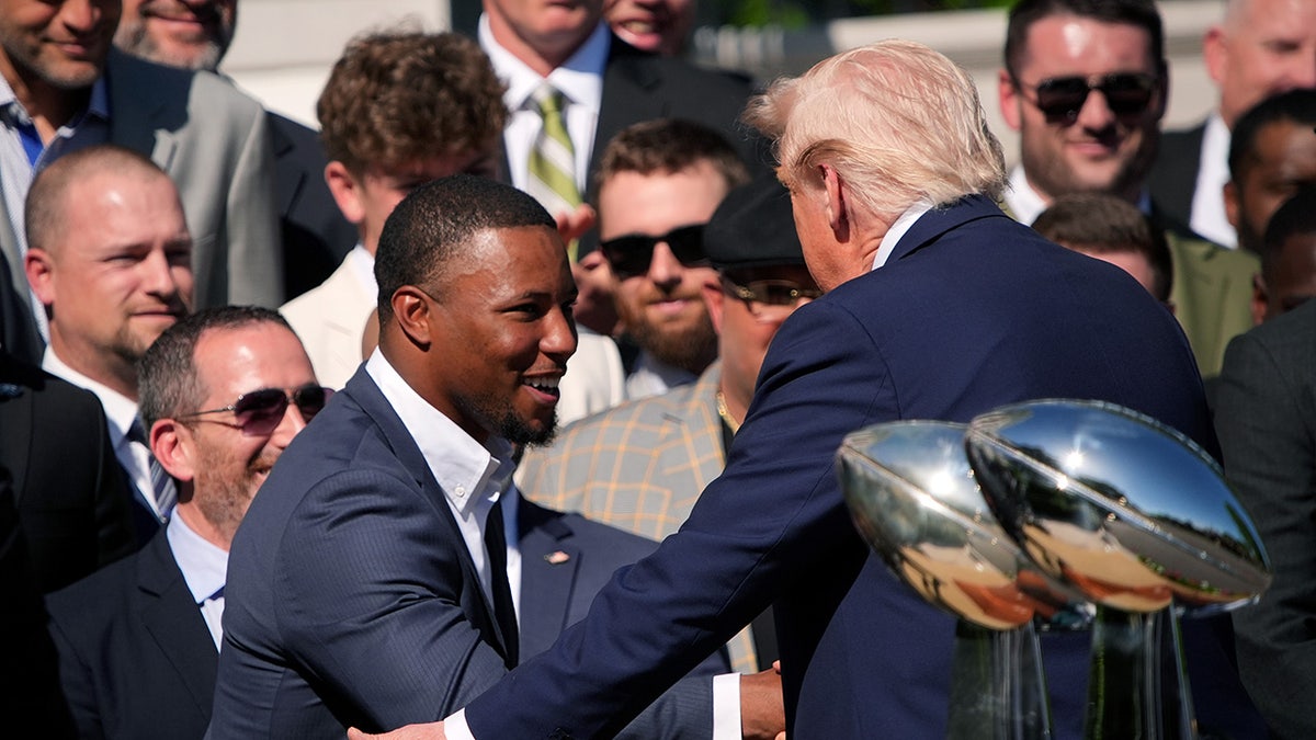 President Donald Trump greets Saquon Barkley