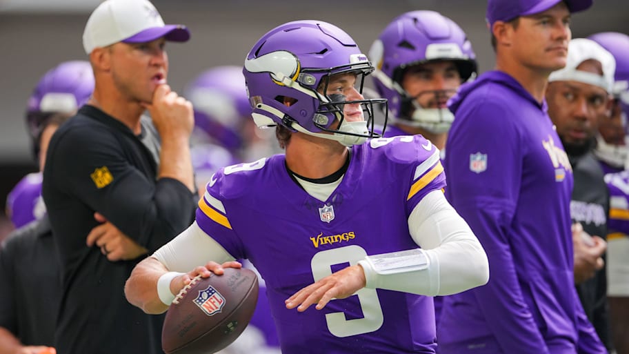 J.J. McCarthy winds up to throw a pass