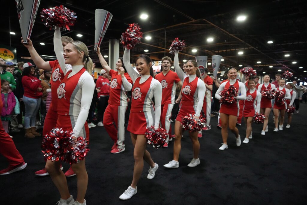 The Ohio State Buckeyes cheerleaders at the College Football Playoff Fan Central at the Georgia World Congress Center.