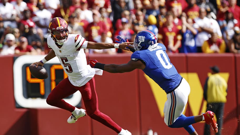 Jayden Daniels tries to evade Brian Burns.