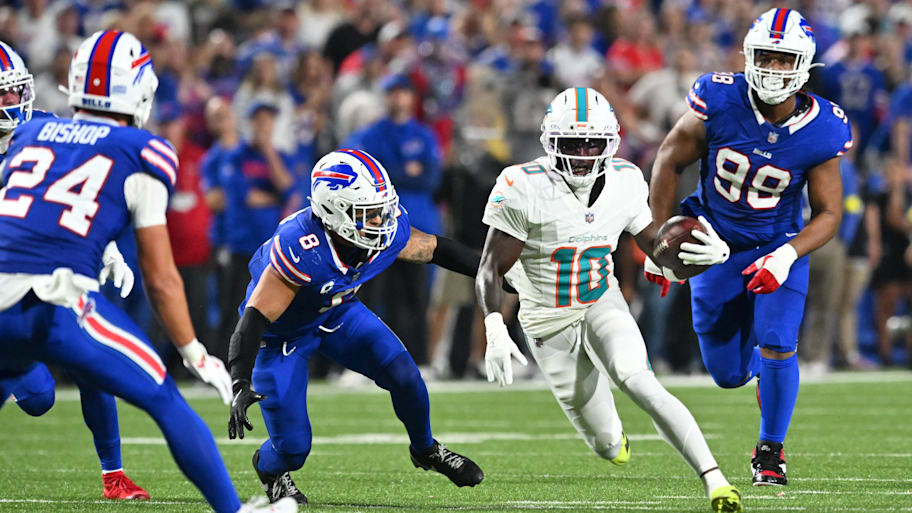 Dolphins wide receiver Tyreek Hill runs against Buffalo Bills linebacker Terrel Bernard (8) and safety Cole Bishop (24).