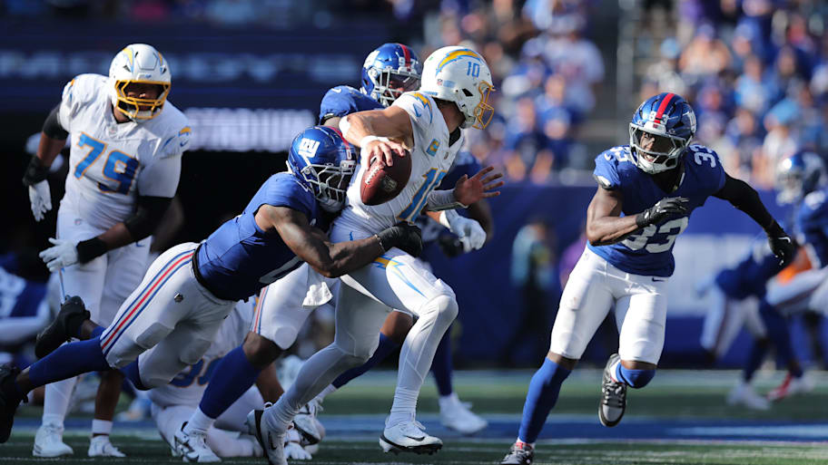 Los Angeles Chargers quarterback Justin Herbert (10) is sacked by New York Giants linebacker Brian Burns