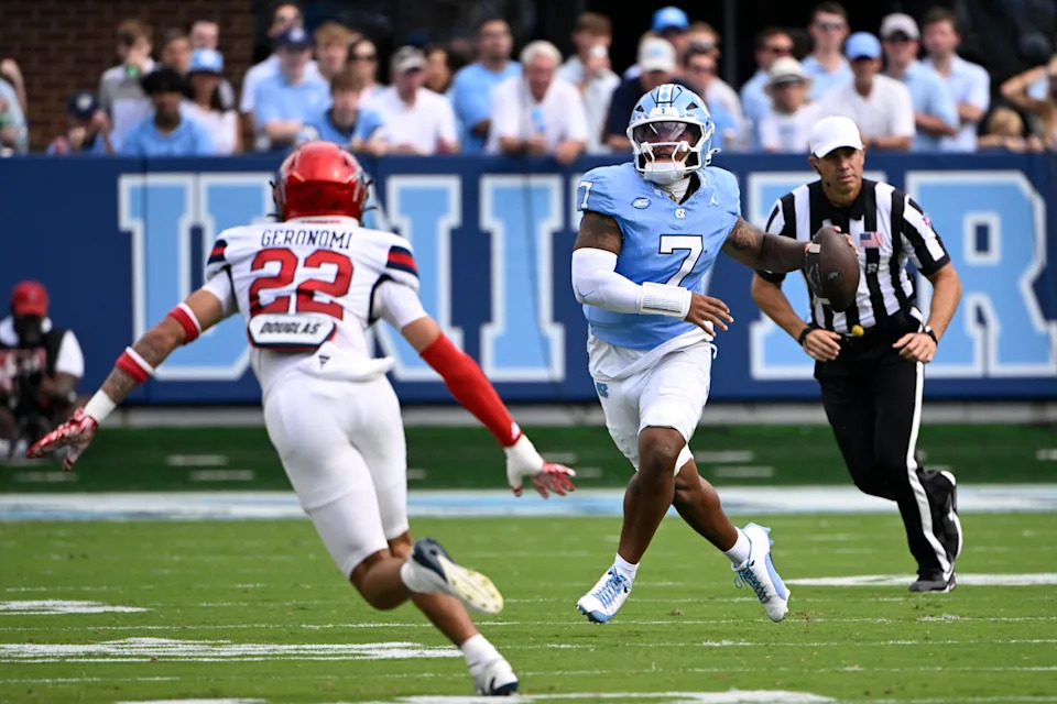 Sep 13, 2025; Chapel Hill, North Carolina, USA; North Carolina Tar Heels quarterback Gio Lopez (7) looks to pass as Richmond Spiders defensive back Devin Geronomi (22) defends in the first quarter at Kenan Stadium. Mandatory Credit: Bob Donnan-Imagn Images