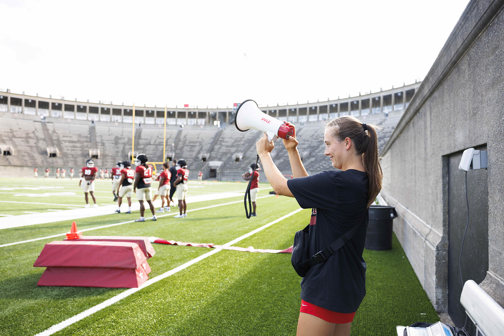 Katie Patton on the field with a megaphone.