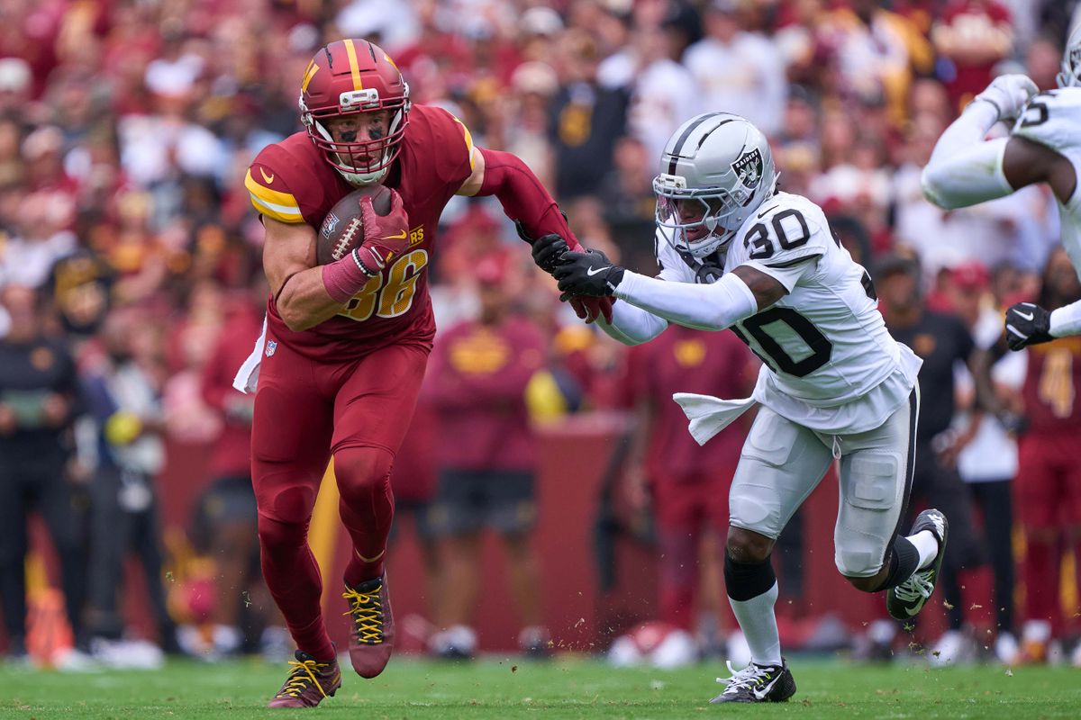Zach Ertz #86 of the Washington Commanders runs with the football past Cornerback Darnay Holmes #30 of the Las Vegas Raiders during the first half against the Las Vegas Raiders during an NFL football game at Northwest Stadium on September 21, 2025 in Landover, Maryland. Zach Ertz #86 of the Washington Commanders runs with the football past Cornerback Darnay Holmes #30 of the Las Vegas Raiders during the first half against the Las Vegas Raiders during an NFL football game at Northwest Stadium on September 21, 2025 in Landover, Maryland.