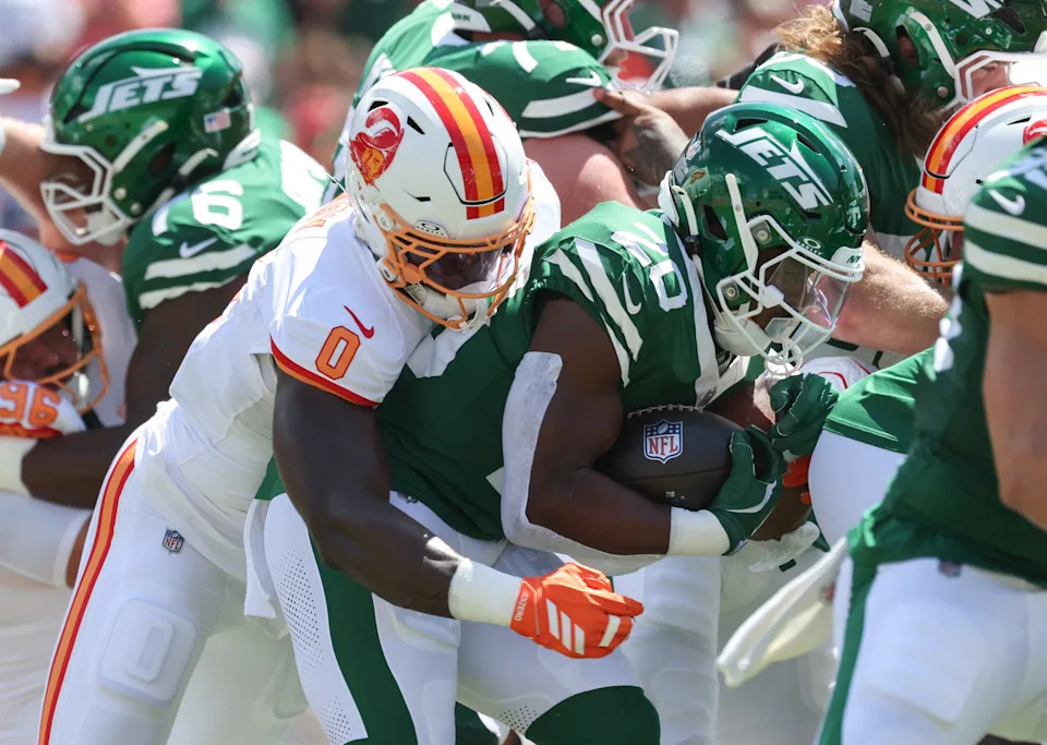 Sep 21, 2025; Tampa, Florida, USA; Tampa Bay Buccaneers linebacker Yaya Diaby (0) tackles New York Jets running back Breece Hall (20) during the first quarter at Raymond James Stadium. Mandatory Credit: Kim Klement Neitzel-Imagn Images