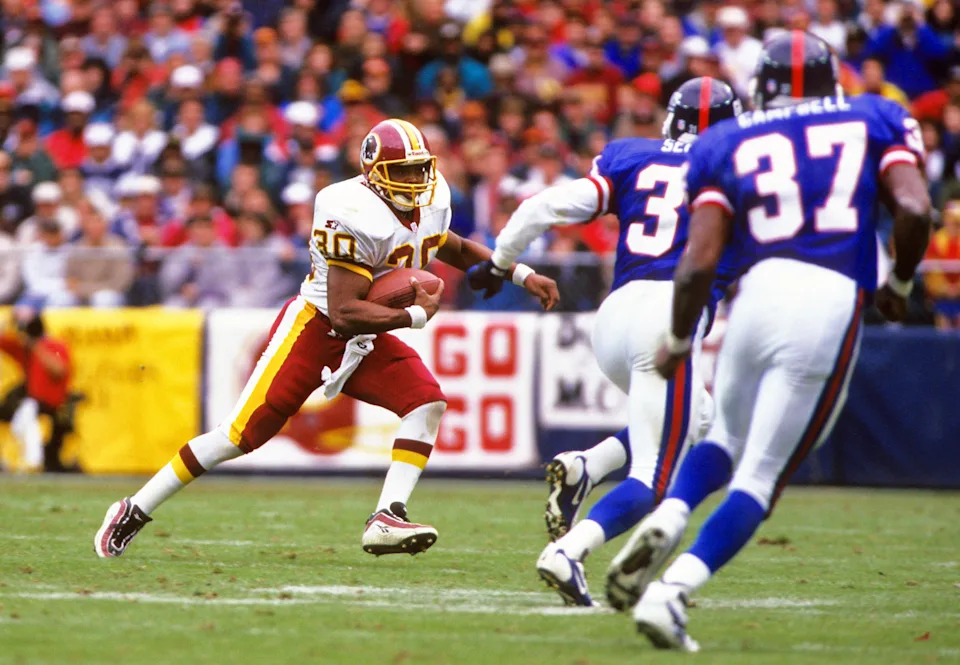 Oct 20, 1996; Washington, DC, USA; FILE PHOTO; Washington Redskins kick returner Brian Mitchell (30) in action against New York Giants defensive backs Jason Sehorn (31) and Jesse Campbell (37) at Robert F. Kennedy Memorial Stadium. Mandatory Credit: Lou Capozzola-USA TODAY NETWORK