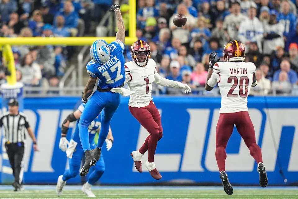Washington Commanders safety Quan Martin intercepts a pass intended for Detroit Lions receiver Tim Patrick during the first half of the NFC divisional round at Ford Field in Detroit on Saturday, Jan. 18, 2025. Martin ran 40 yards for a touchdown and 24-14 lead.
