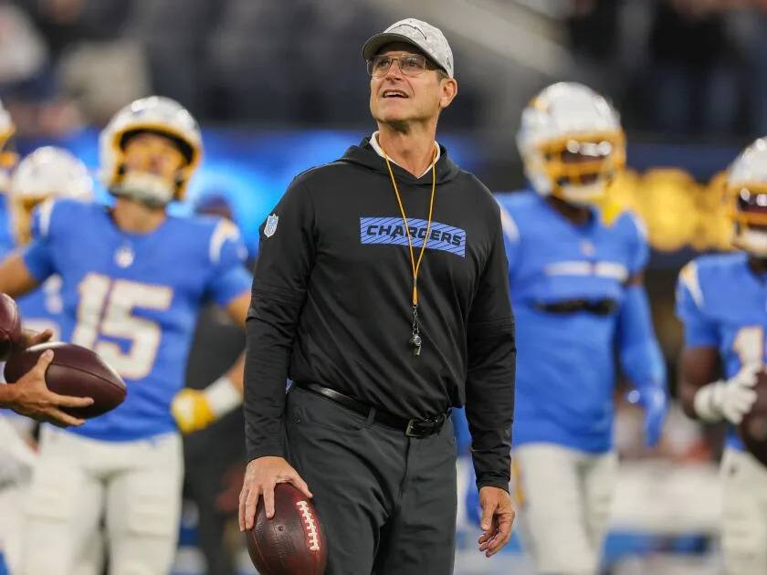 Chargers coach Jim Harbaugh watches players warm up before a game against the Bengals.