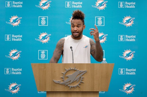 Miami Dolphins quarterback Tua Tagovailoa talks to the media after...