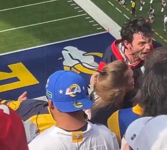 Excited Rams fans celebrating in the stands.