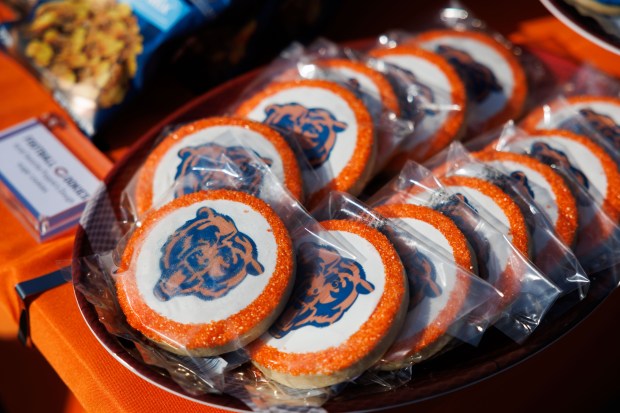Cookies sit on a table while fans tailgate outside Soldier...