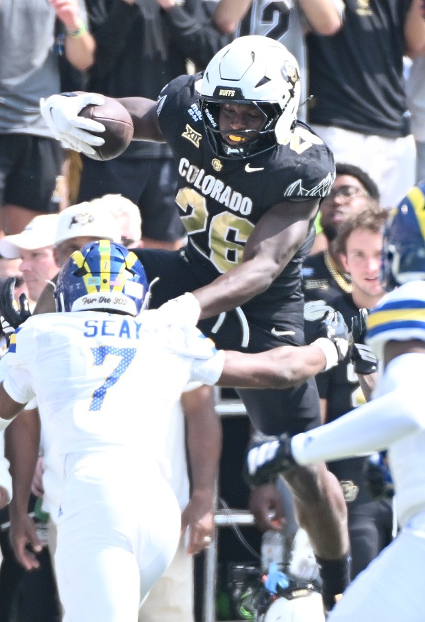 Colorado Buffaloes running back Simeon Price tries to jump over Delaware's KT Seay during a NCAA football game in Boulder, Colo., on Sept. 6, 2025.(Cliff Grassmick/Staff Photographer)