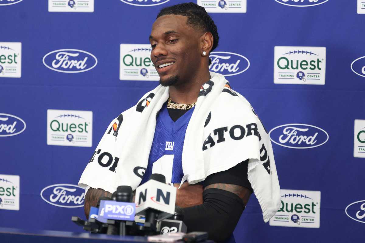 Malik Nabers: Giants player with white towel around his neck in front of blue background