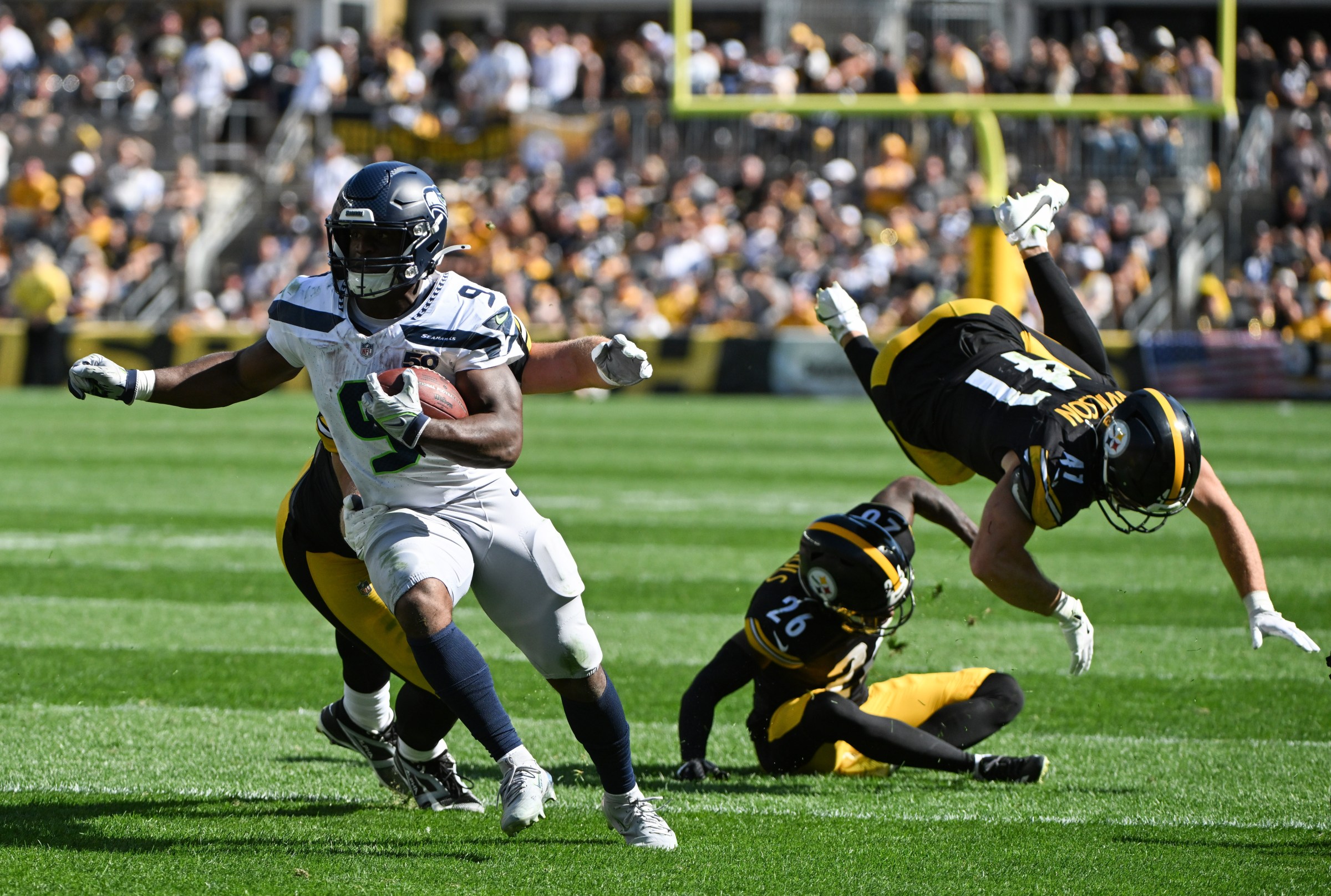 Sep 14, 2025; Pittsburgh, Pennsylvania, USA; Seattle Seahawks running back Kenneth Walker III (9) scores a touchdown in front of Pittsburgh Steelers defenders Brandin Echols (26) and Payton Wilson (41) during the second half at Acrisure Stadium. Mandatory Credit: Barry Reeger-Imagn Images