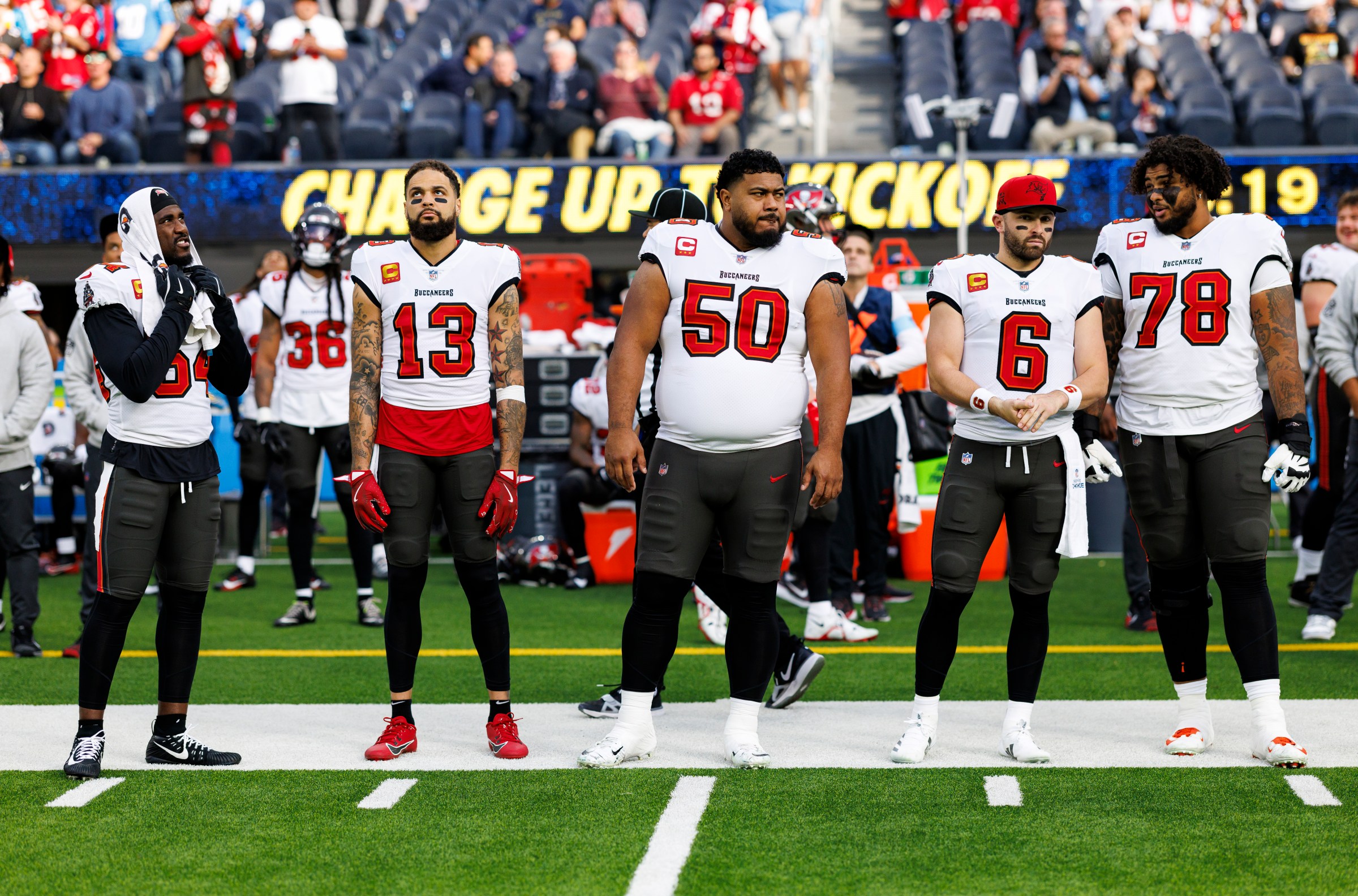 INGLEWOOD, CALIFORNIA - DECEMBER 15: Linebacker Lavonte David #54 of the Tampa Bay Buccaneers, wide receiver Mike Evans #13, defensive tackle Vita Vea #50, quarterback Baker Mayfield #6, and offensive tackle Tristan Wirfs #78 stand on the sidelines prior to an NFL football game against the Los Angeles Chargers, at SoFi Stadium on December 15, 2024 in Inglewood, California. (Photo by Brooke Sutton/Getty Images)