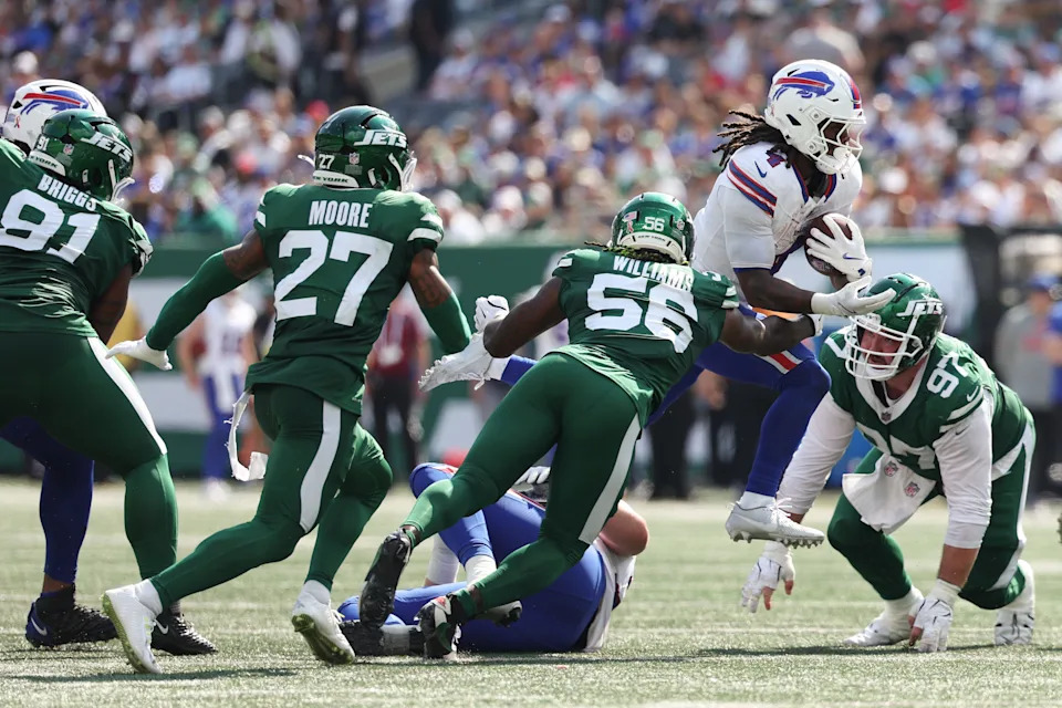 EAST RUTHERFORD, NEW JERSEY - SEPTEMBER 14: Harrison Phillips #97 and Quincy Williams #56 of the New York Jets tackle James Cook #4 of the Buffalo Bills during the third quarter at MetLife Stadium on September 14, 2025 in East Rutherford, New Jersey. (Photo by Jordan Bank/Getty Images)