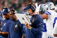 Dallas Cowboys head Coach Brian Schottenheimer calls a play during the first half of an NFL...