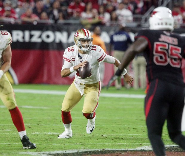 49ers quarterback Jimmy Garoppolo #10 runs for a first down during the San Francisco 49ers 28-25 defeat of the Arizona Cardinals at State Farm Stadium on October 31, 2019 in Glendale, Arizona.Photo by John Medina