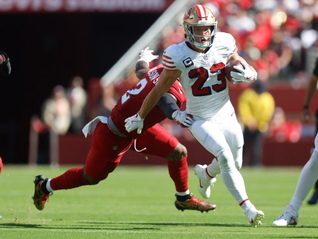 San Francisco 49ers' Christian McCaffrey (23) runs against Arizona Cardinals' Mack Wilson Sr. (2) in the third quarter at Levi's Stadium in Santa Clara, Calif., on Sunday, Sept. 21, 2025. (Nhat V. Meyer/Bay Area News Group)