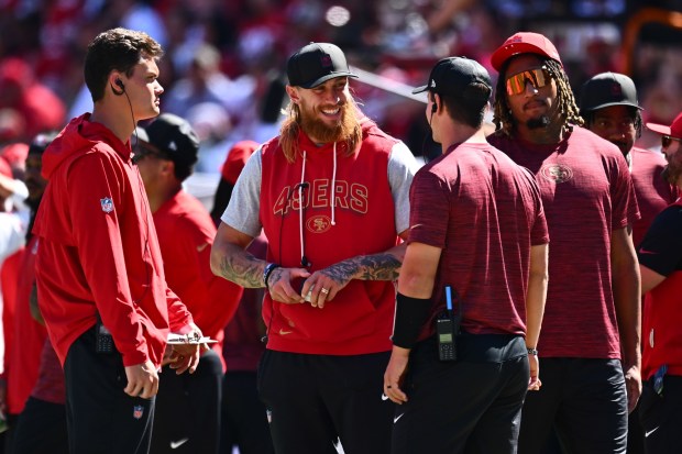 San Francisco 49ers George Kittle (85) smiles while talking to quarterback Brock Purdy (13) on the sideline in the second quarter of their NFL game at Levi's Stadium in Santa Clara, Calif., on Sunday, Sept. 21, 2025. (Jose Carlos Fajardo/Bay Area News Group)