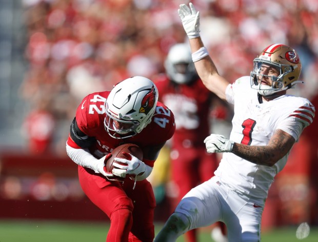 Arizona Cardinals' Dadrion Taylor-Demerson (42) makes an interception against San Francisco 49ers' Ricky Pearsall (1) in the fourth quarter at Levi's Stadium in Santa Clara, Calif., on Sunday, Sept. 21, 2025. (Nhat V. Meyer/Bay Area News Group)
