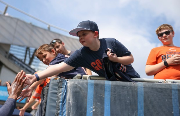 Chicago Bears fans greet players before their game against the...