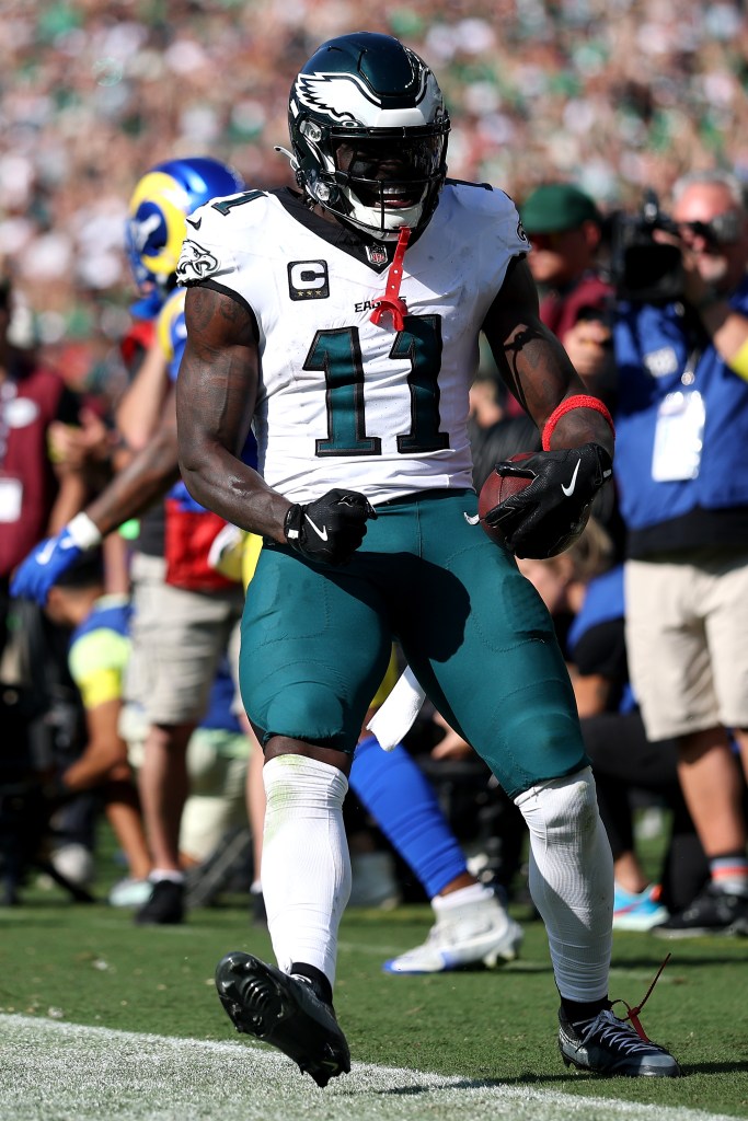 Philadelphia Eagles wide receiver A.J. Brown holds the football and celebrates a touchdown.