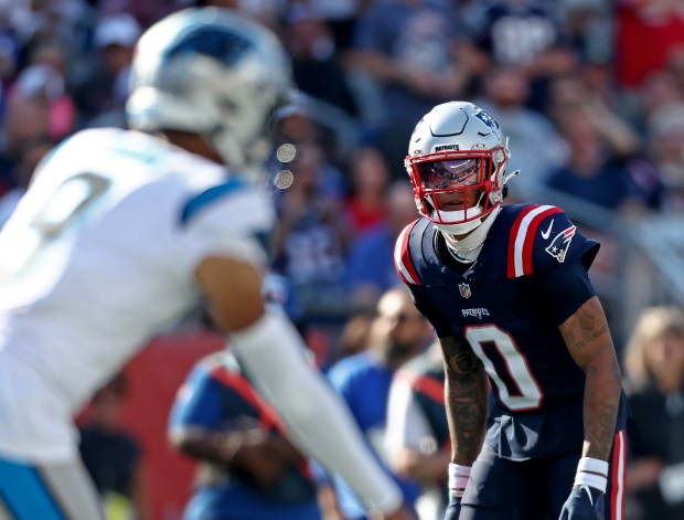 Foxboro, MA -New England Patriots' Christian Gonzalez keeps an eye on Carolina Panthers quarterback Bryce Young during the third quarter of the game at Gillette Stadium. (Nancy Lane/Boston Herald)