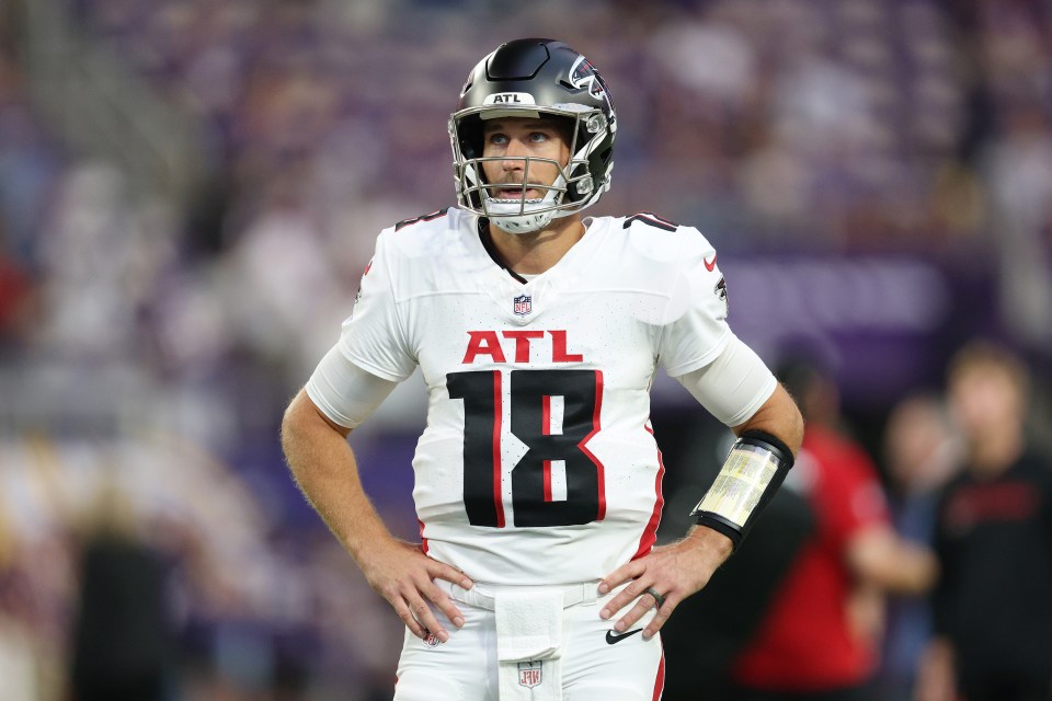 Kirk Cousins, wearing an Atlanta Falcons jersey and helmet, looking to his right.