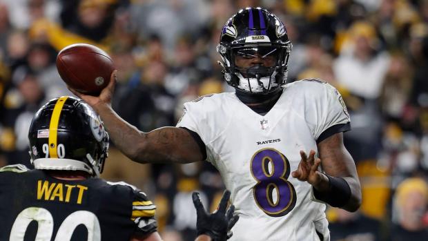 Ravens quarterback Lamar Jackson looks to pass over Steelers linebacker T.J. Watt during a game Dec. 5, 2021, in Pittsburgh. (Winslow Townson, AP)