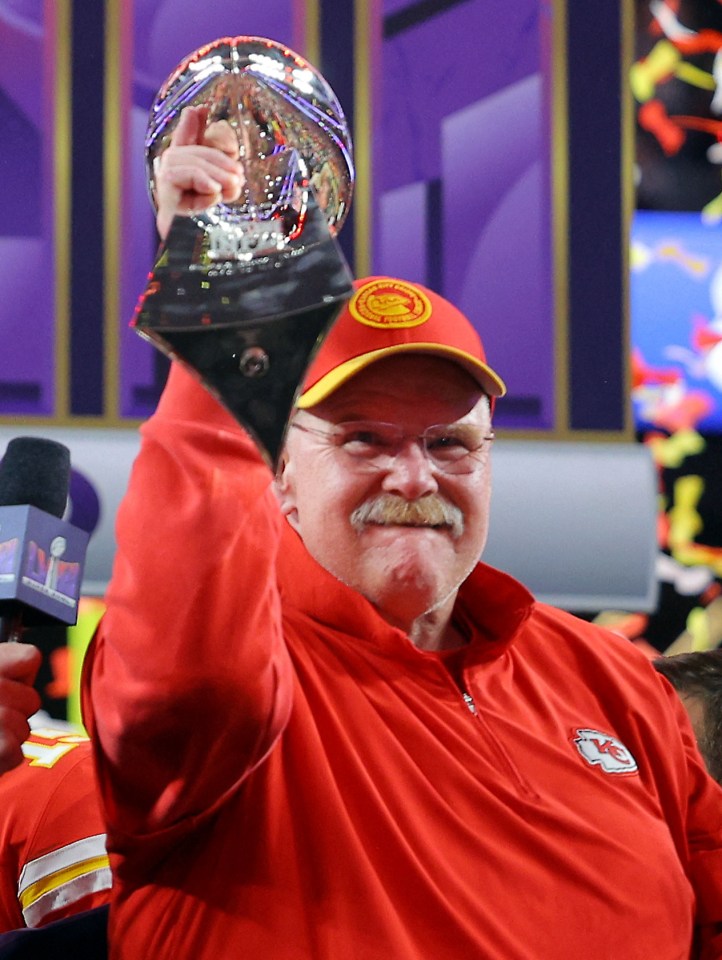 Andy Reid holding the Vince Lombardi Trophy.