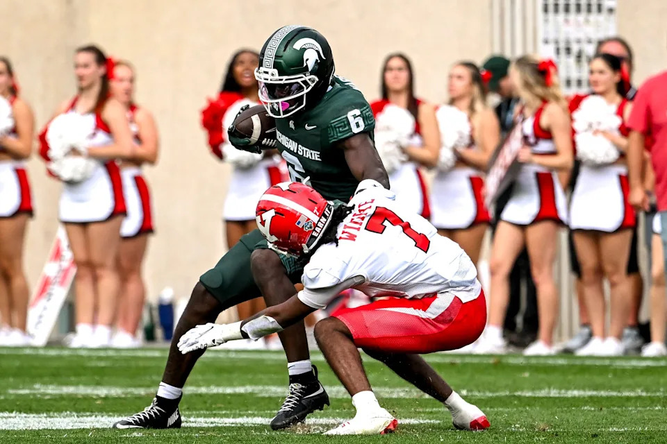 Michigan State's Nick Marsh, left, spins off a tackle attempt by Youngstown State's Justin Wimpye during the second quarter on Saturday, Sept. 13, 2025, at Spartan Stadium in East Lansing.