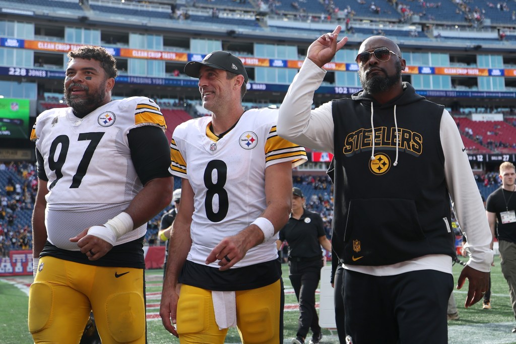 Cameron Heyward #97, Aaron Rodgers #8 and Head coach Mike Tomlin of the Pittsburgh Steelers walk off the field after their 21-14 win over the New England Patriots at Gillette Stadium on September 21, 2025 in Foxborough, Massachusetts. 