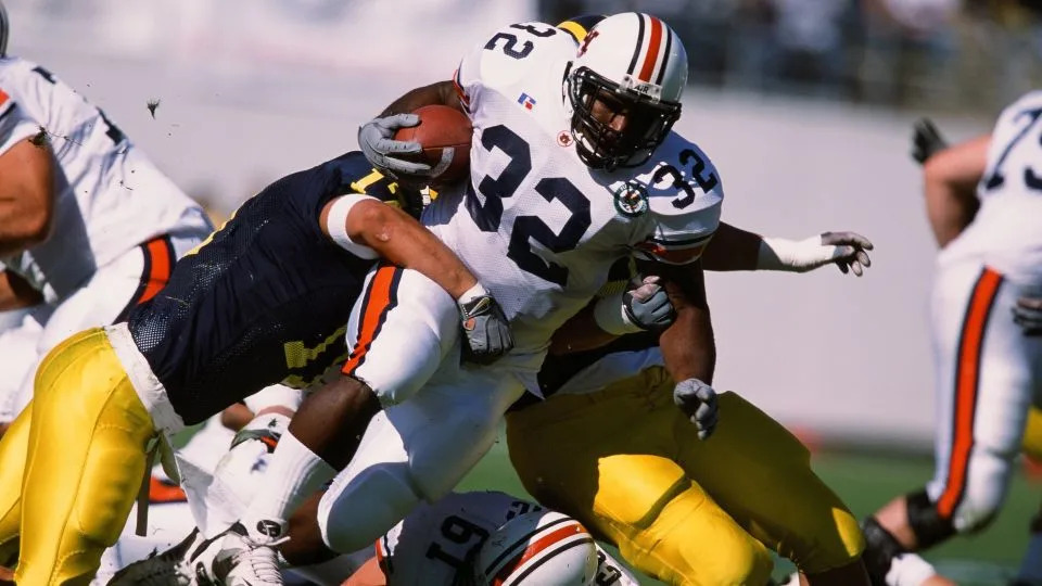 Auburn's Rudi Johnson runs with the ball against Michigan in 2001. - The Sporting News/Getty Images
