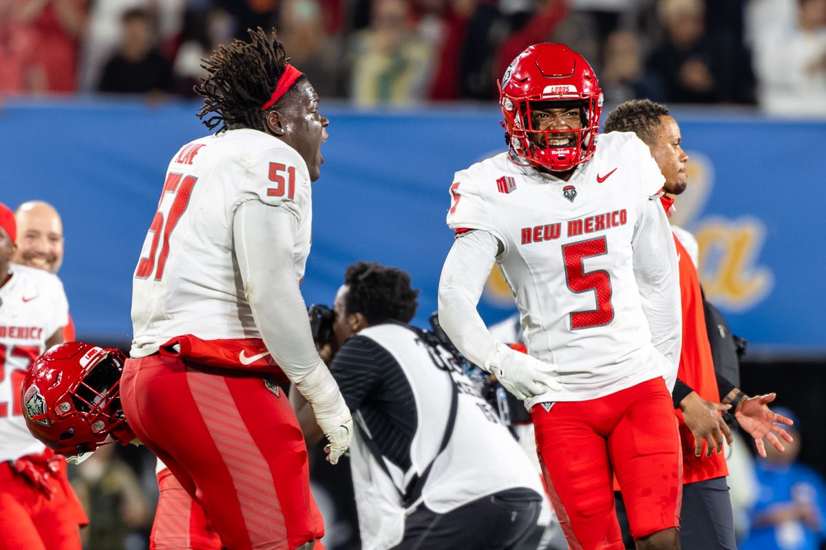 Offensive lineman Malik Aliane #51 of the New Mexico Lobos and cornerback Frankie Edwards III #5 of the New Mexico Lobos celebrate the victory after an NCAA football game against the UCLA Bruins at the Rose Bowl on September 12, 2025 in Pasadena, California.