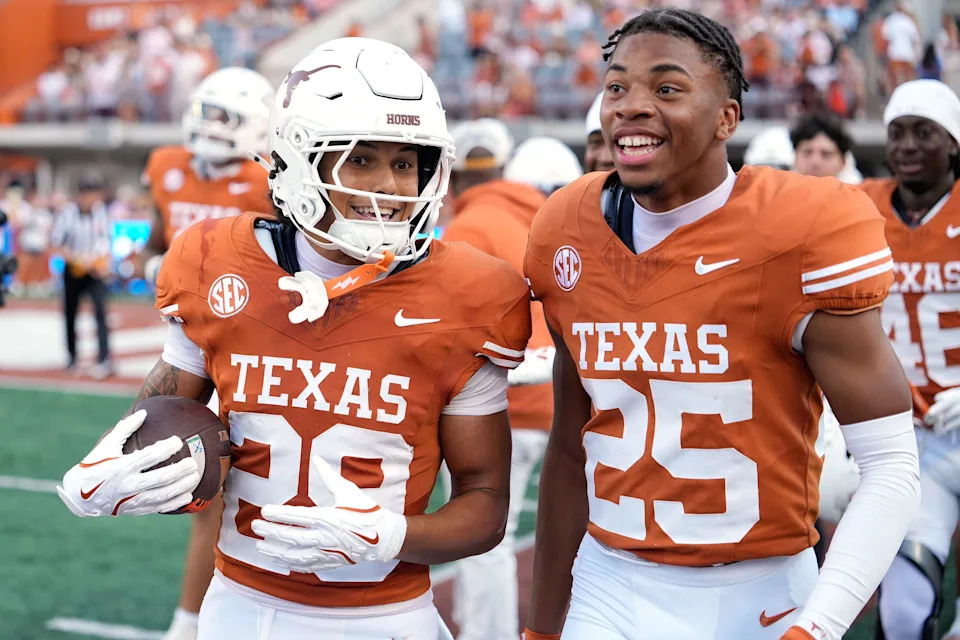 Sep 13, 2025; Austin, Texas, USA; Texas Longhorns defensive backs Graceson Littleton (29) and Caleb Chester (25) react after Littleton made an interception during the second half against the Texas El Paso Miners at Darrell K Royal-Texas Memorial Stadium. Mandatory Credit: Scott Wachter-Imagn Images