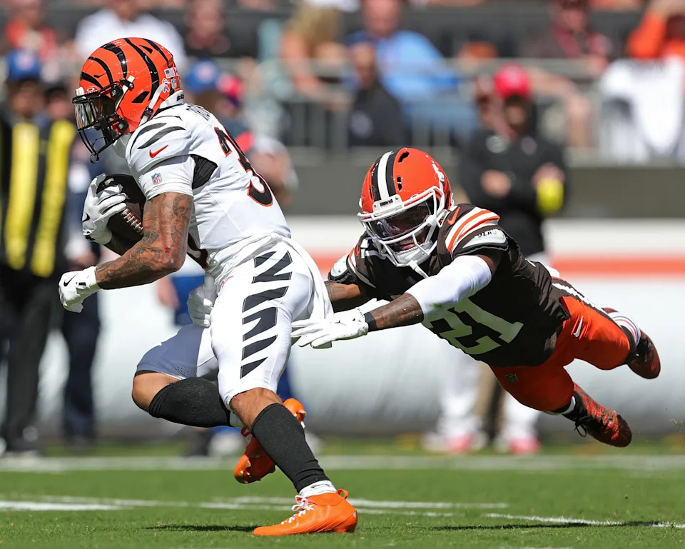 Cleveland Browns cornerback Denzel Ward (21) makes a diving tackle attempt of Cincinnati Bengals running back Chase Brown on Sept. 7, 2025, in Cleveland.